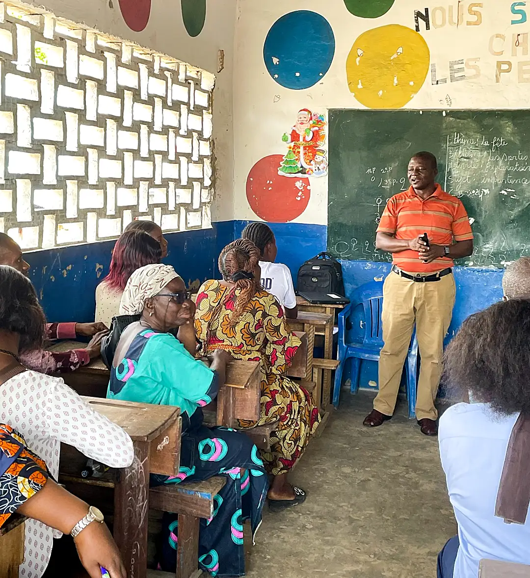 Photo of a group of adults in a classroom in the Democratic Republic of the Congo