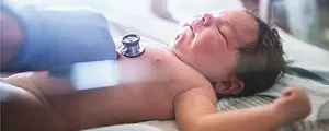 A newborn baby receives a medical checkup.