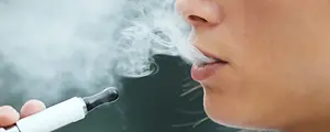 Closeup of a young woman using an electronic cigarette