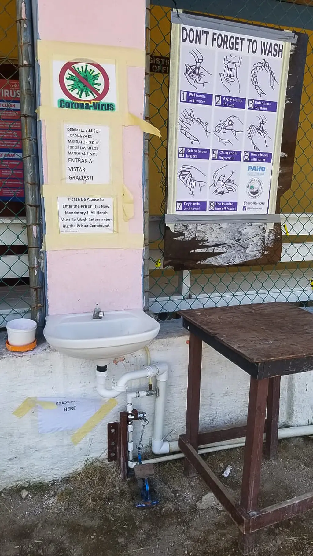 A sign at the Belize Central Prison reminds visitors to wash their hands to help prevent COVID-19.