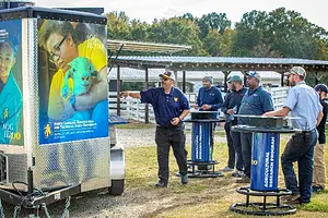 NC A&T’s Gregory Goines giving a presentation to farmers on solar-powered charging trailers