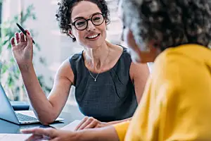 Consultant talks to client in office