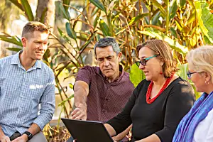 Group of people looks at computer