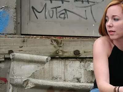 young woman sitting broken steps graffiti 
