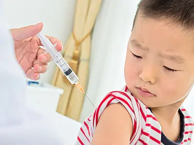 A boy receives a vaccine injection