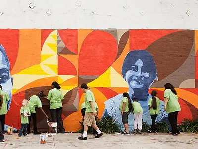 Group painting a bright mural