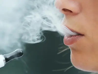 Closeup of a young woman using an electronic cigarette