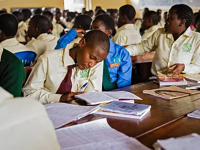 A student follows an English reading lesson in Masaka, Uganda
