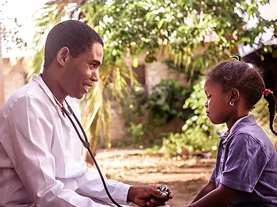 Doctor examines a child in Tanzania
