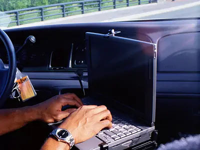 Police officer access information via a laptop computer in his squad car