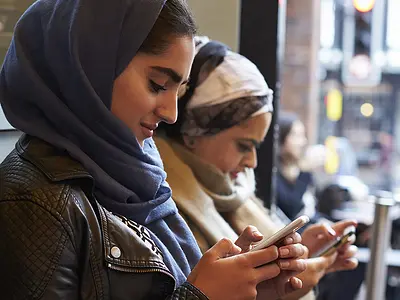 Group of women using mobile devices
