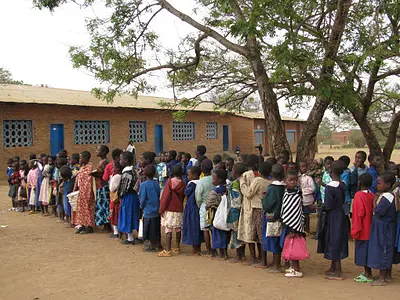 Children in Malawi line up for school