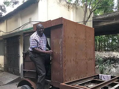 Dennis Mwanza, an RTI sanitation expert originally from Zambia, drives an emptying truck.