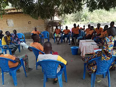 A community health meeting in Guinea, site of the Stop Palu + project.
