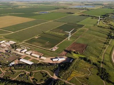 Aerial shot of farmland with wind turbines
