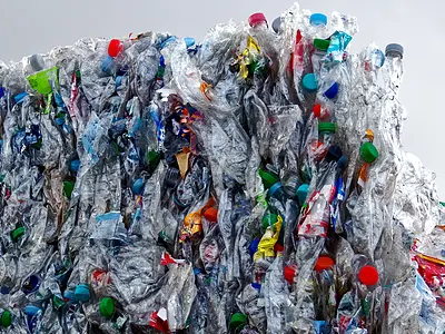 A large cube of plastic bottles, compacted for disposal.
