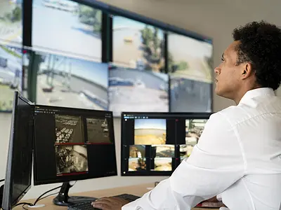 employee checking security footage on monitors
