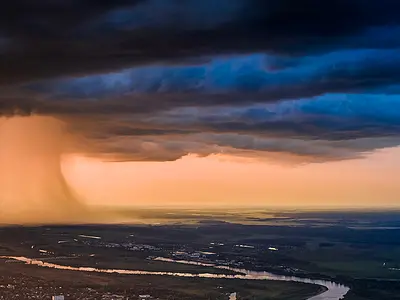Large rain cloud over a town. Aerial drone footage. 