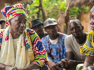 Health workers discuss malaria prevention in Guinea.