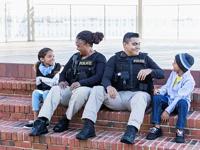 Photo of two police officers smiling with children