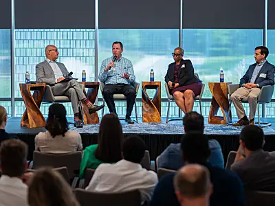 Photo of four panelists at RTI on stage having a discussion