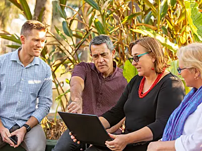 Group of people looks at computer