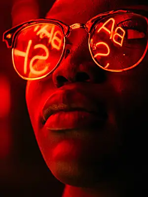 Person with glasses looking at an illuminated sign