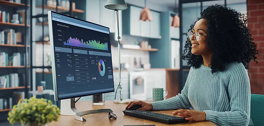 Woman working on a research project on a desktop computer at a desk