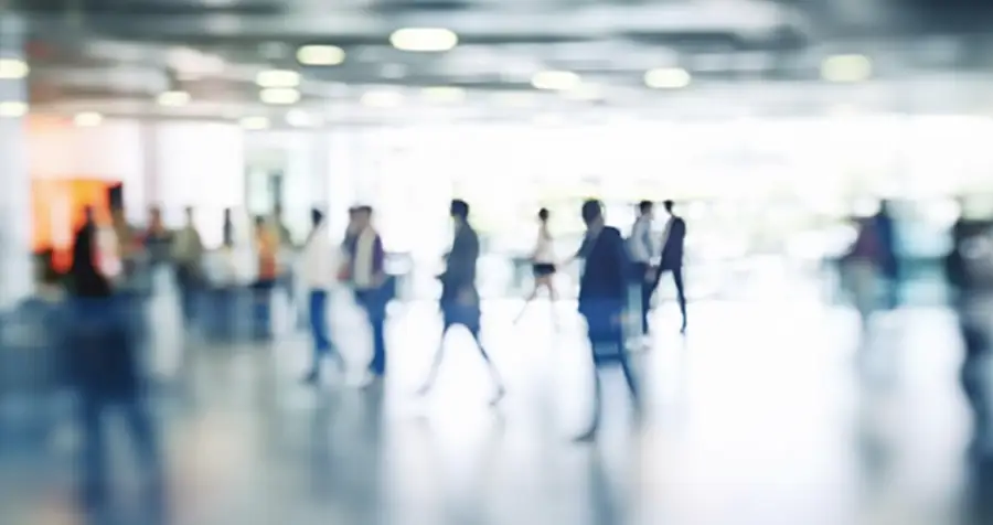 Image of blurred people in motion indoors