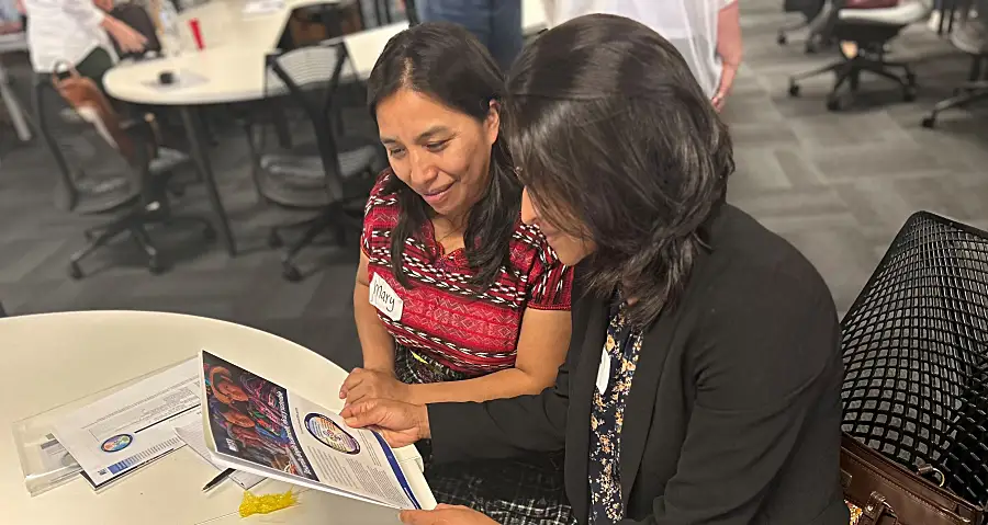 Guatemala women looking at brochure