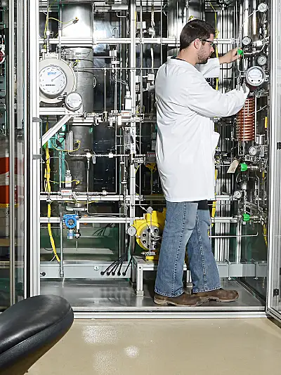 Scientist man using hydrotreater equipment