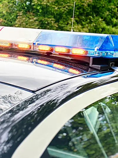 Police cars on a city street in the daytime