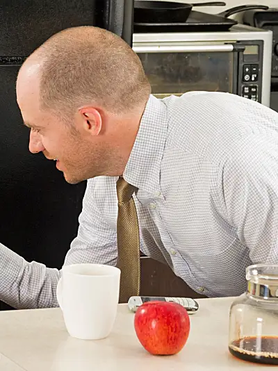 baby in highchair high five man at laptop