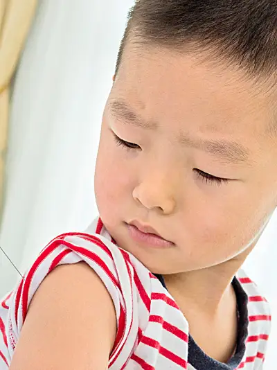 A boy receives a vaccine injection