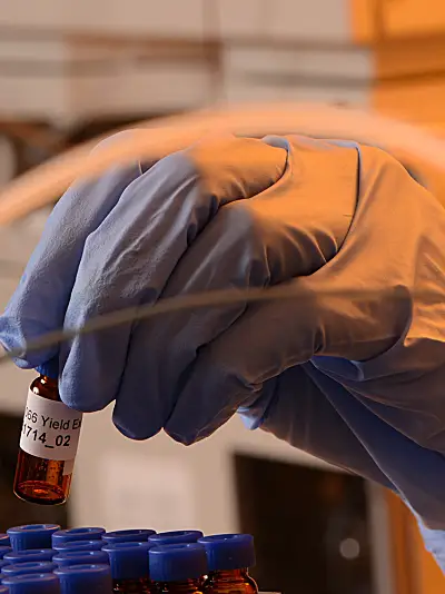 woman in bitotech lab holding sample