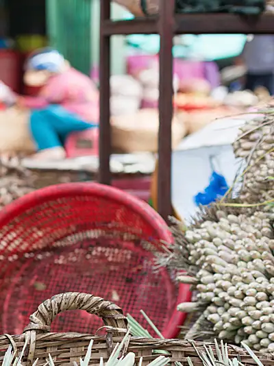 A male vendor in an Asian food market