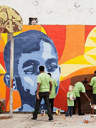 Group painting a bright mural