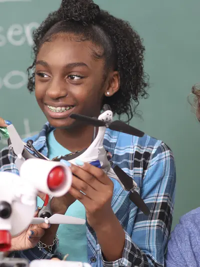 Students looking at a robot