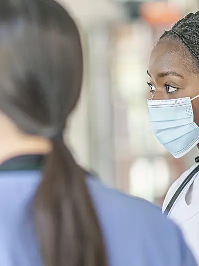 two doctors and a nurse discussing patient care