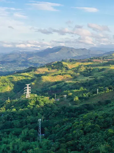 Wind turbines stand along a ridgeline on the island of Luzon in the Philippines.