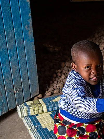 Photo of two youngRwandan children drinking milk