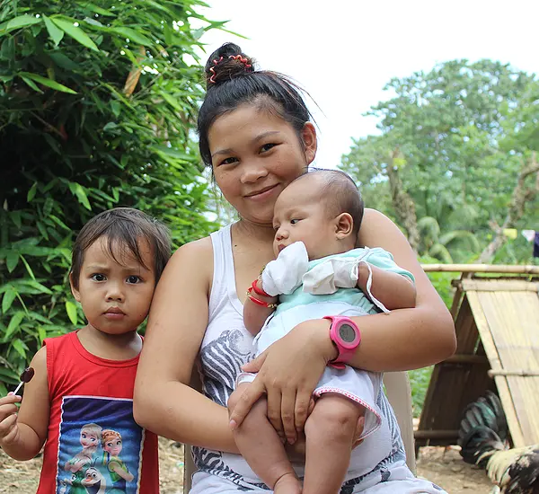 A teen mother and her children in the Philippines.