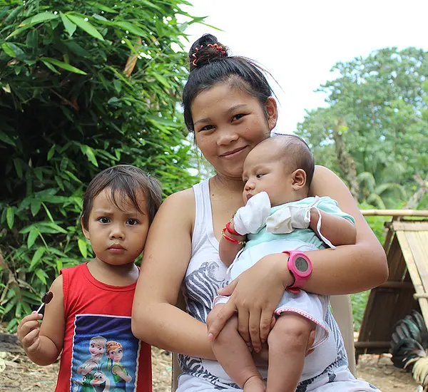A teen mother and her children in the Philippines.