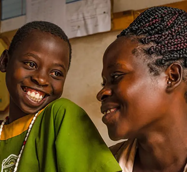 Agnes Nansere Nassaka and her daughter, Justine Nakyejwe. Justine is one of 4.4 million students across Uganda who are learning to love reading thanks to two USAID-funded early grade reading programs implemented in partnership with Uganda’s Ministry of Ed