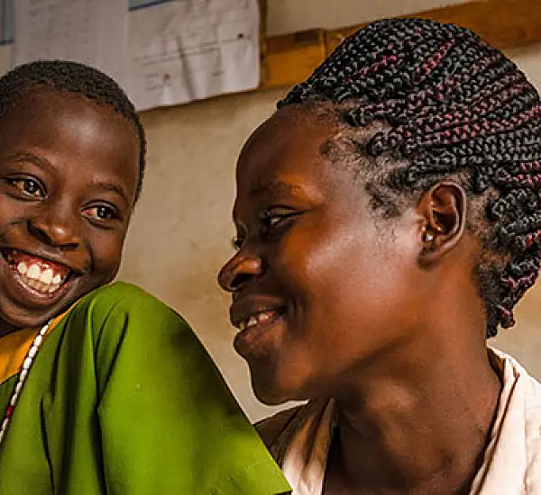 Agnes Nansere Nassaka and her daughter, Justine Nakyejwe. Justine is one of 4.4 million students across Uganda who are learning to love reading thanks to two USAID-funded early grade reading programs implemented in partnership with Uganda’s Ministry of Ed