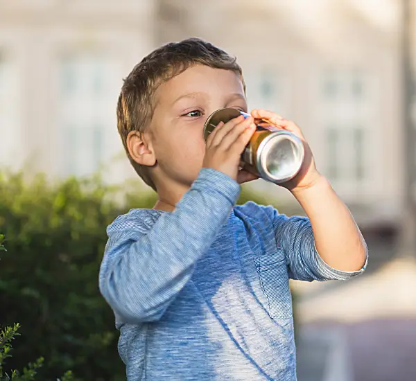 child drinking soda