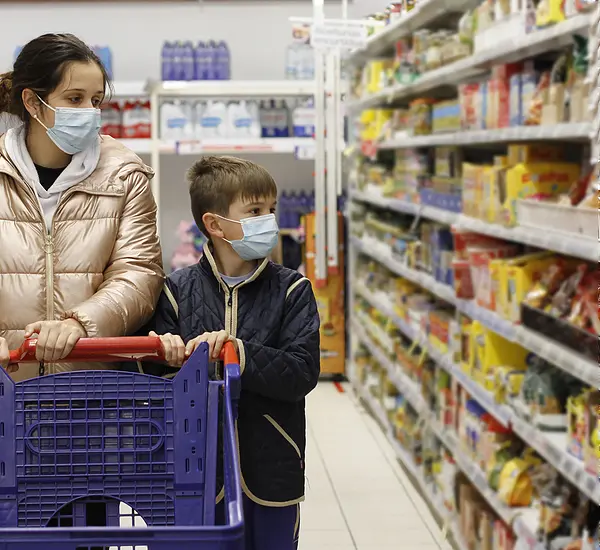Mother and child wearing mask at the grocery store 