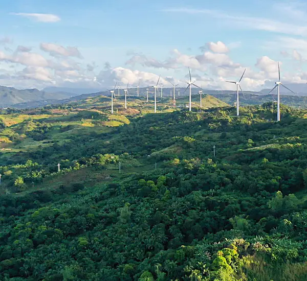 Wind turbines stand along a ridgeline on the island of Luzon in the Philippines.