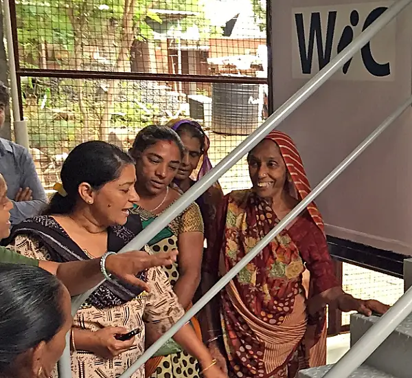 Photo of people surrounding a new toilet prototype in India