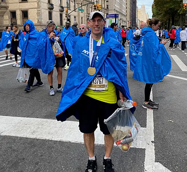 Marcus with his metal after running the 2021 NYC marathon